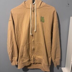 American Eagle Outfitters Tan Zip-Up Hoodie with Green Frog Patch